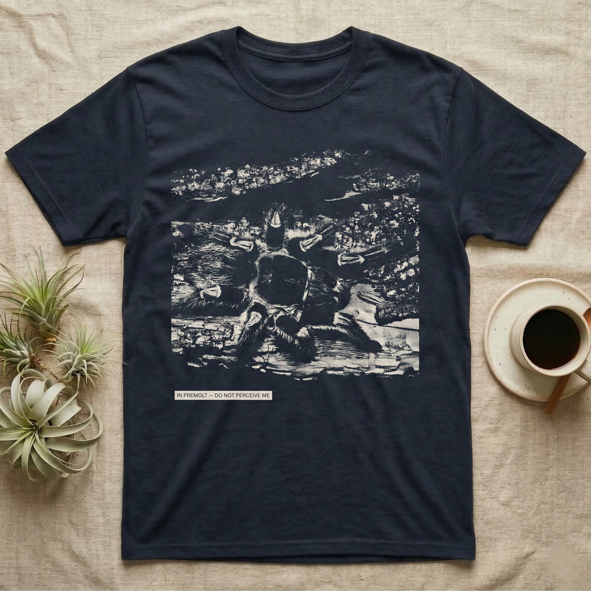 In Premolt Tarantula T-Shirt in Navy — Dark macro illustration of a tarantula curled in its hide with a small tag reading "In Premolt, Do Not Perceive Me."