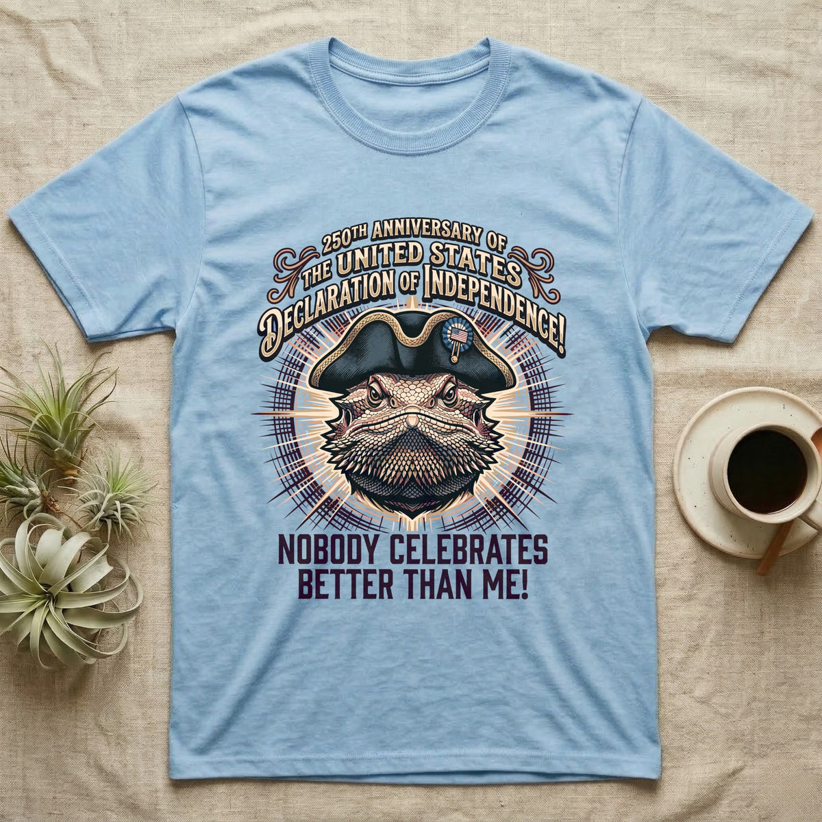 Bearded Dragon Declaration T-Shirt in Light Blue — Ornate engraved bearded dragon portrait in a tricorn hat on a cream sunburst with Nobody Celebrates Better Than Me.