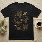 Scorpion Cosmic T-Shirt in Black — Vintage screen-print illustration of scorpions in astronaut helmets floating in space, cosmic amber monochromatic on dark background.