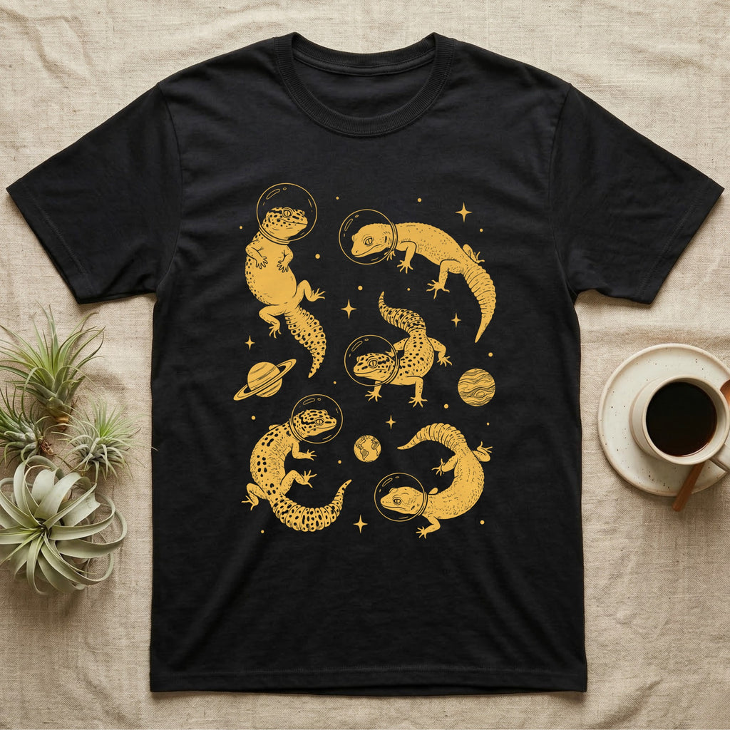 Leopard Gecko Cosmic T-Shirt in Black — Vintage screen-print illustration of leopard geckos in astronaut helmets floating in space, sulfur amber monochromatic on dark background.