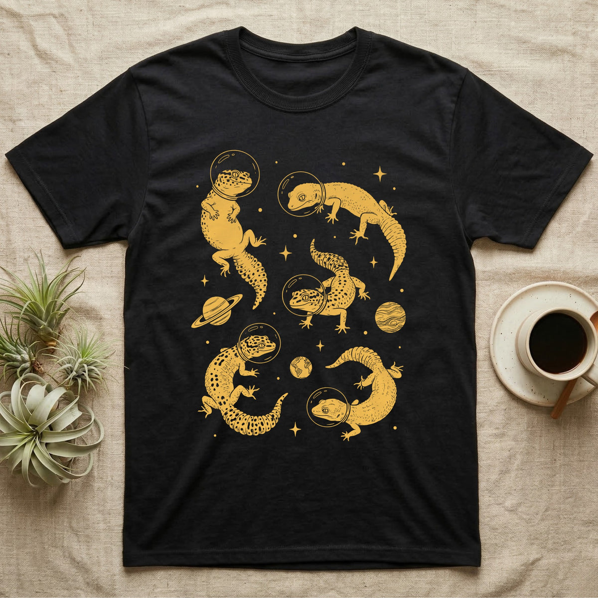 Leopard Gecko Cosmic T-Shirt in Black — Vintage screen-print illustration of leopard geckos in astronaut helmets floating in space, sulfur amber monochromatic on dark background.