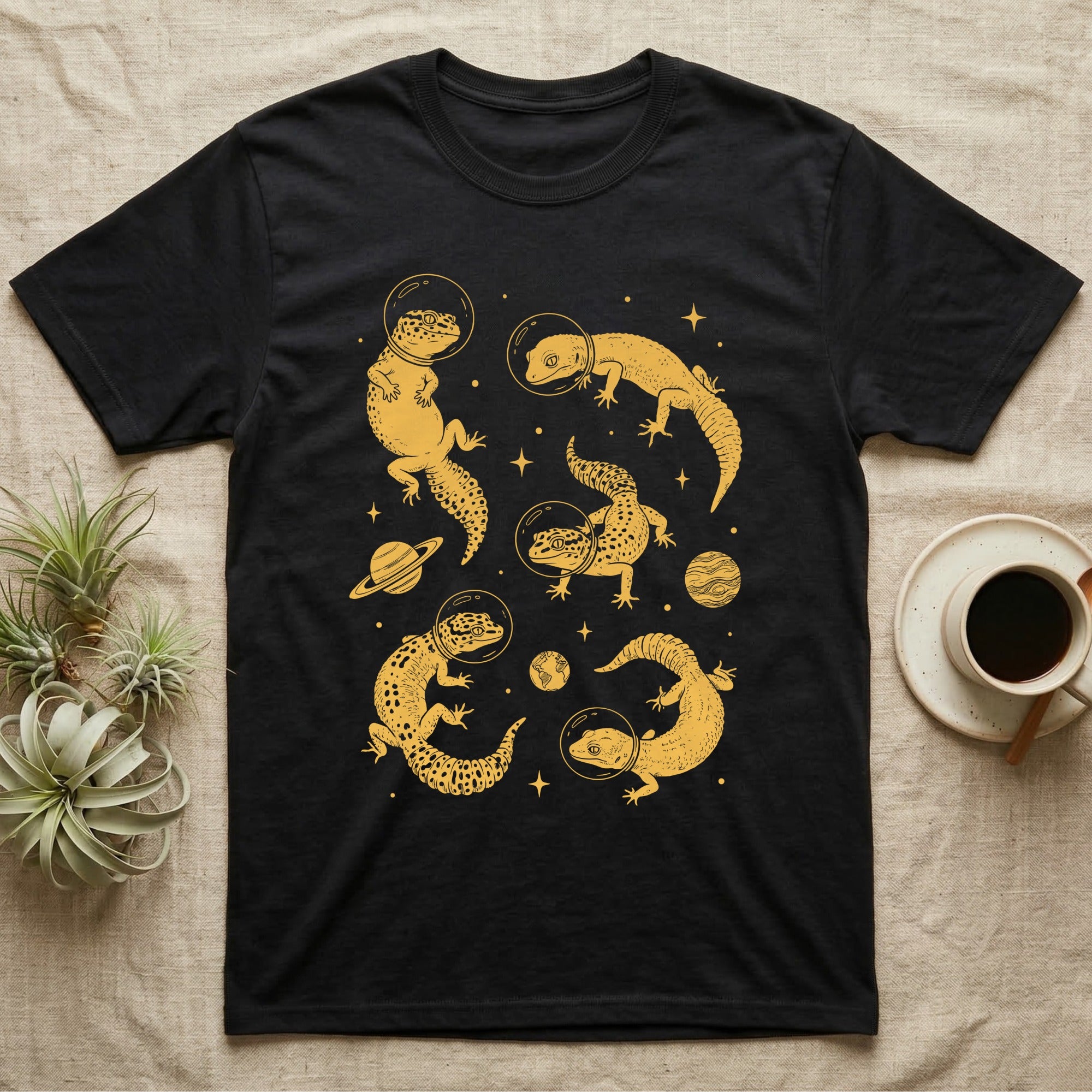 Leopard Gecko Cosmic T-Shirt in Black — Vintage screen-print illustration of leopard geckos in astronaut helmets floating in space, sulfur amber monochromatic on dark background.