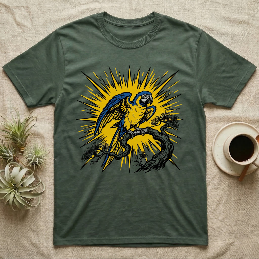 T-shirt featuring a blue and yellow macaw perched on a stylized tree branch with a sunburst background.