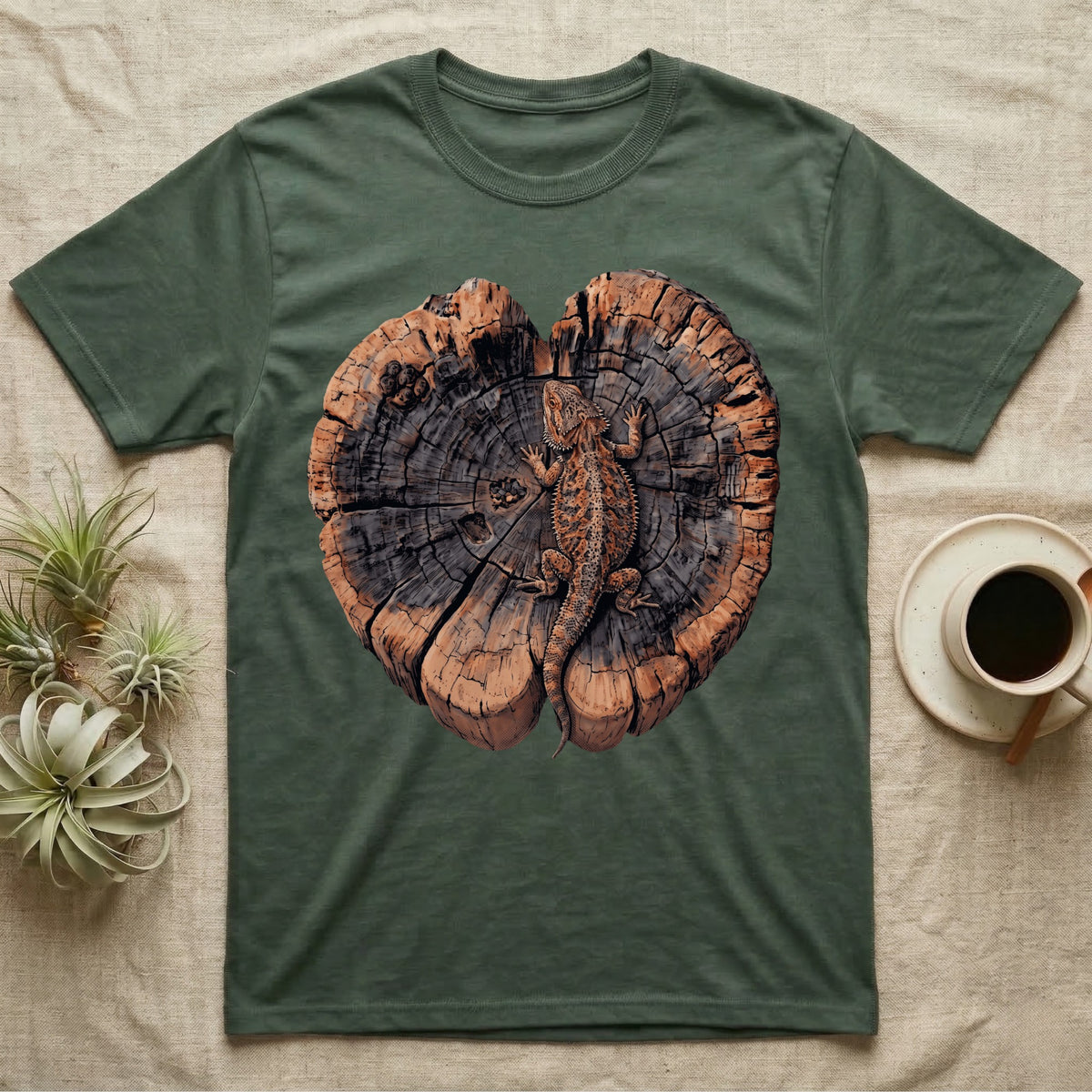 Bearded Dragon Basking Rings T-Shirt in Military Green — Top-down illustration of a bearded dragon splayed flat on a cross-section log slab of terracotta growth rings with bracket fungus, no on-shirt text.