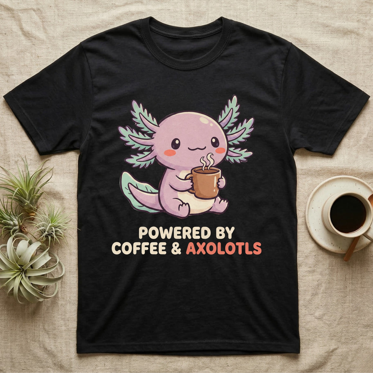 Coffee And Axolotls T-Shirt in Black — Kawaii chibi illustration of an axolotl holding a coffee cup with soft text reading Powered By Coffee And Axolotls.
