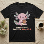 Coffee And Axolotls T-Shirt in Black — Kawaii chibi illustration of an axolotl holding a coffee cup with soft text reading Powered By Coffee And Axolotls.