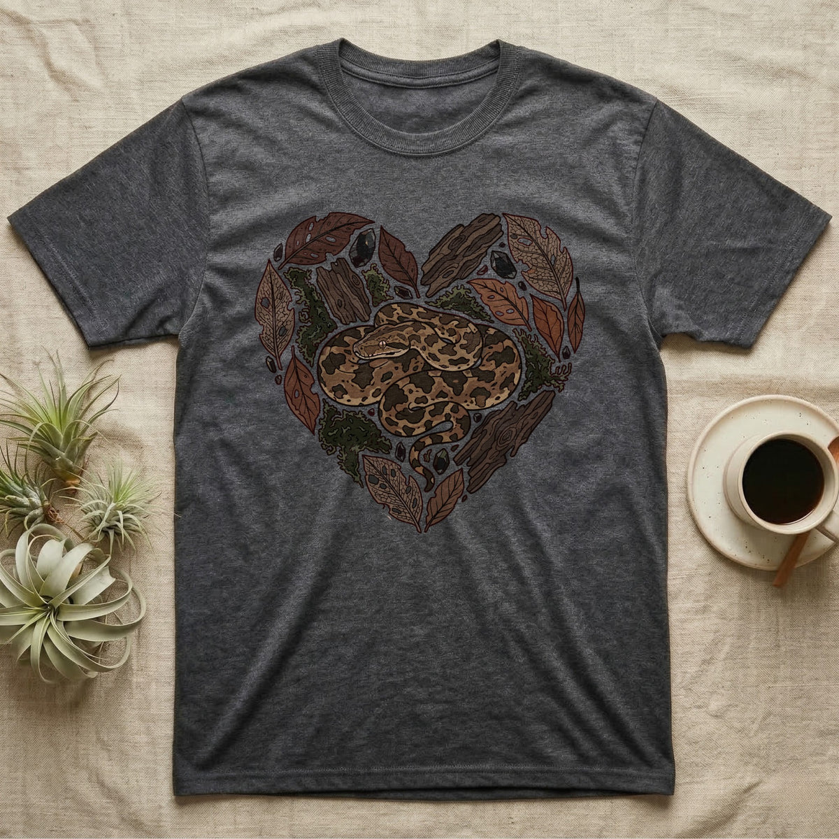 Dark grey t-shirt with snake and leaves forming a heart graphic.