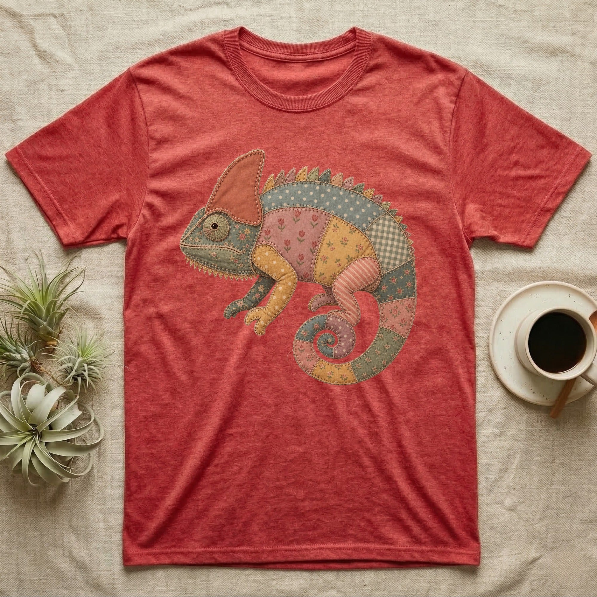 Quilted patchwork chameleon graphic on a heather red t-shirt.