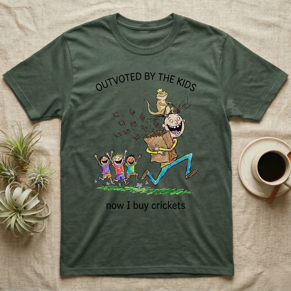 Lizard Dad Outvoted T-Shirt in Military Green — Crayon drawing of a crowned bearded dragon riding a grinning dad who carries a bag of crickets while three kids cheer, under Outvoted By The Kids, now I buy crickets