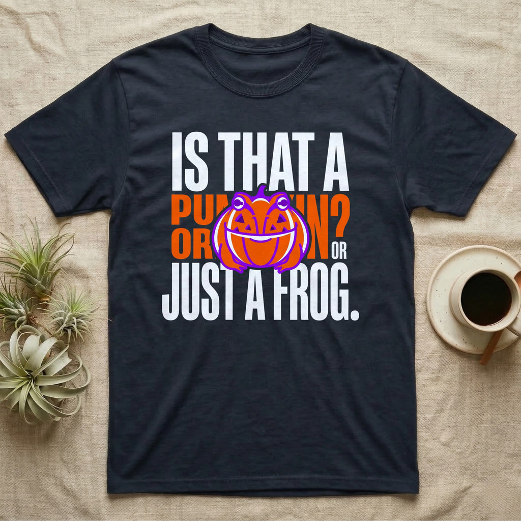 Frog Jack-O'-Lantern Illusion T-Shirt in Navy — Typographic graphic of an orange frog doubling as a jack-o'-lantern, "Is That a Pumpkin? Or Just a Frog."