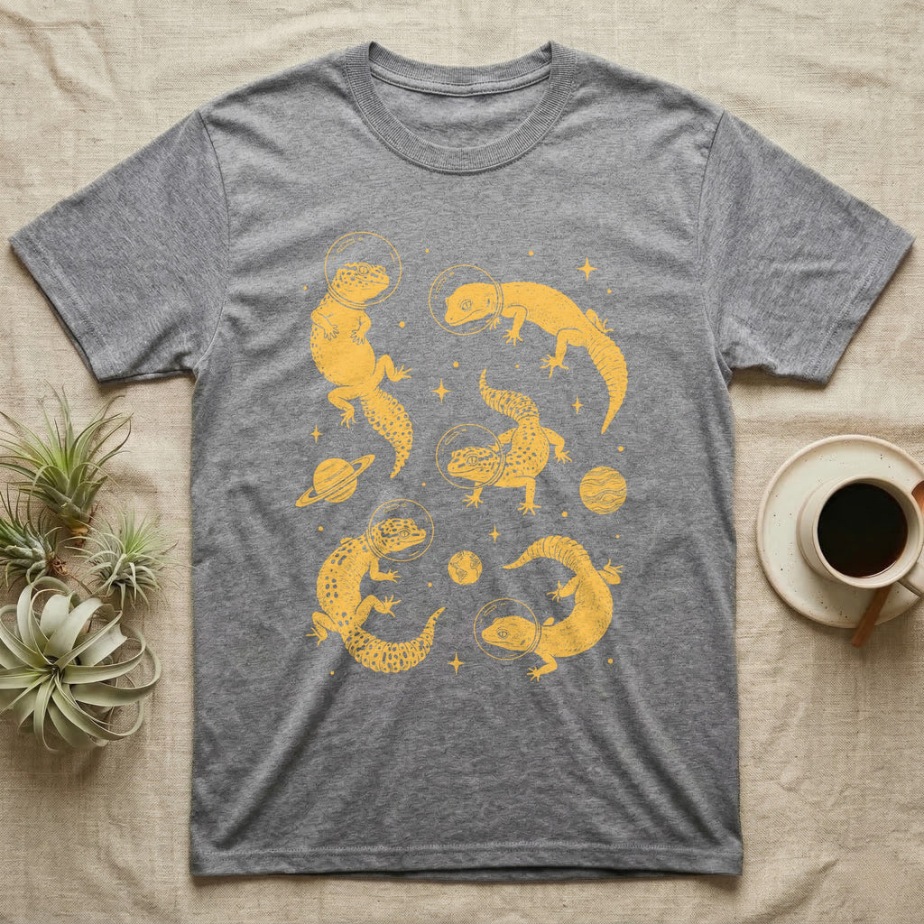 Leopard Gecko Cosmic T-Shirt in Sport Grey — Vintage screen-print illustration of leopard geckos in astronaut helmets floating in space, sulfur amber monochromatic on dark background.