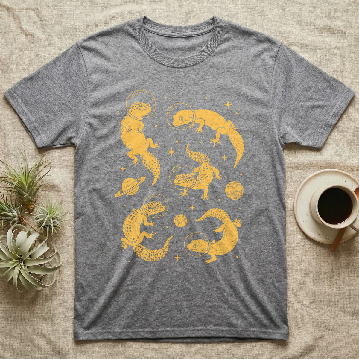 Leopard Gecko Cosmic T-Shirt in Sport Grey — Vintage screen-print illustration of leopard geckos in astronaut helmets floating in space, sulfur amber monochromatic on dark background.