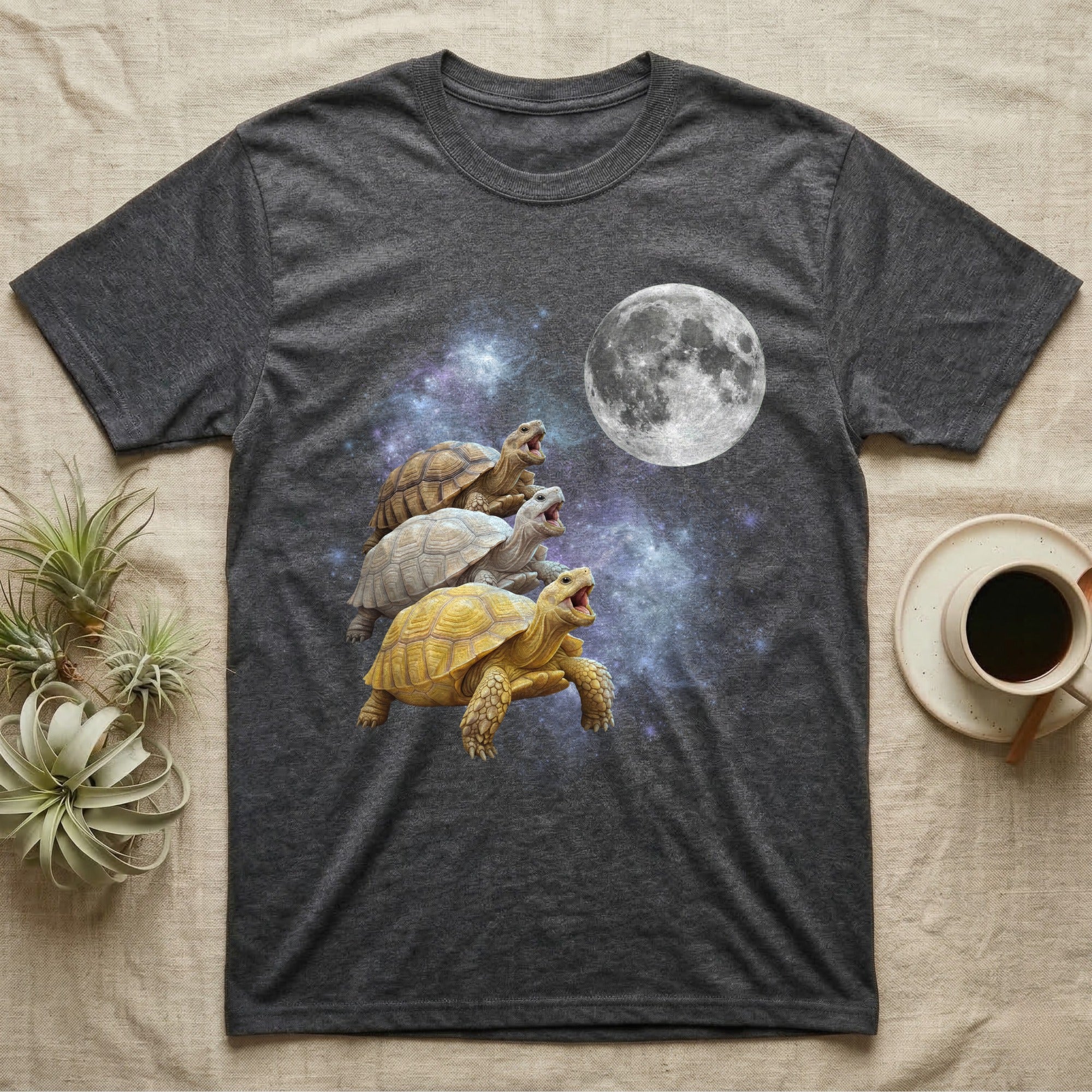 Sulcata Tortoise Moon Howl T-Shirt in Dark Heather — Three Sulcata Tortoise colour morphs howling at a full moon over a nebula on a dark grey t-shirt.
