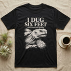 Sulcata Tortoise Dug Six Feet T-Shirt in Black — One-ink white sulcata tortoise portrait on black under the words I DUG SIX FEET and I am still going.
