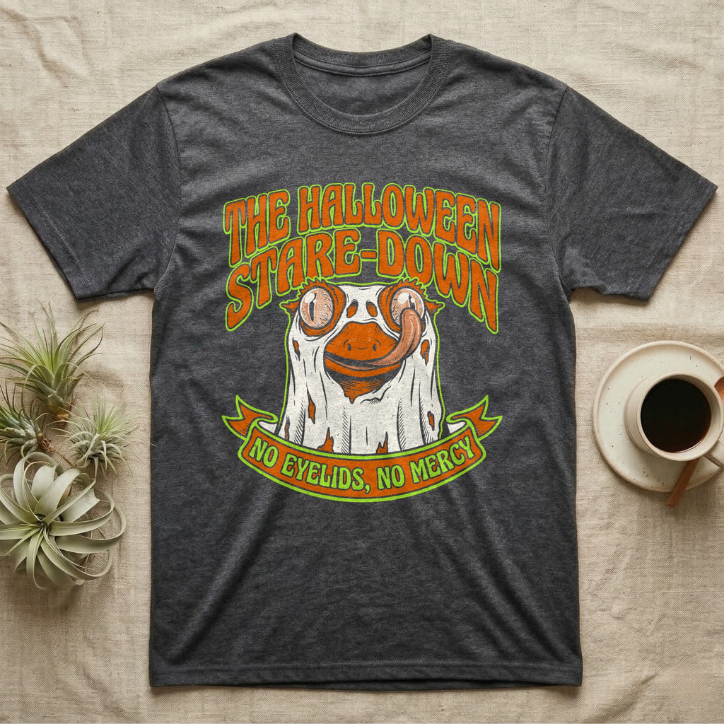 Crested Gecko Halloween Stare-Down T-Shirt in Dark Heather — Retro-horror crested gecko in a ghost sheet licking its eye, "The Halloween Stare-Down, No Eyelids No Mercy."