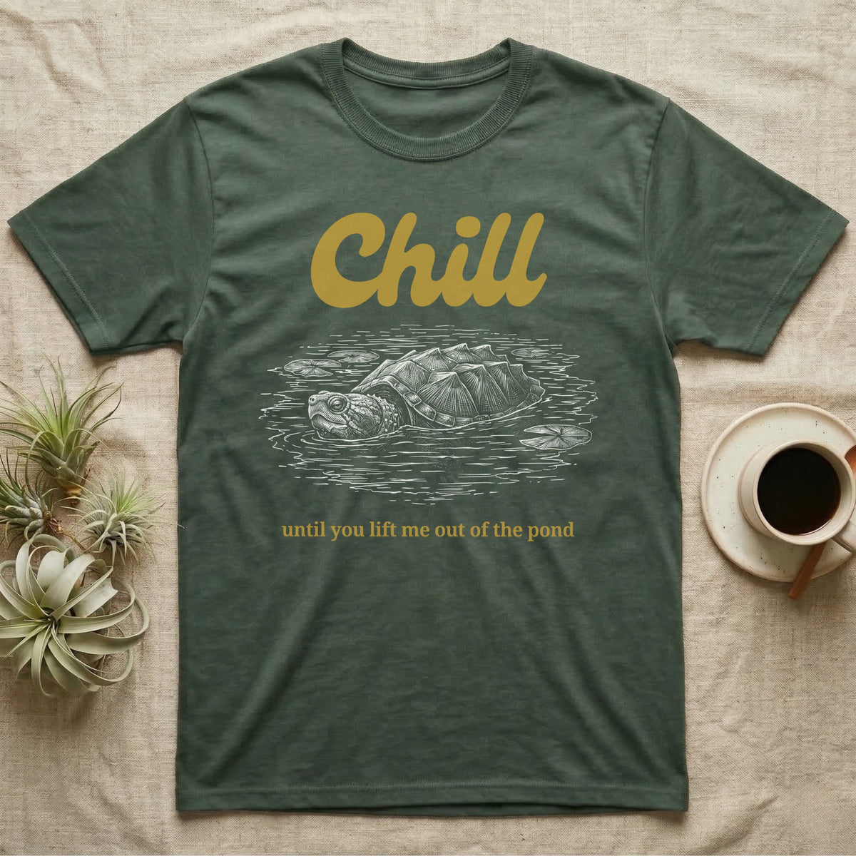 Snapping Turtle Chill T-Shirt in Military Green — White-line engraving of a snapping turtle floating among lily pads under the word Chill