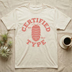 Isopod Certified Morph T-Shirt in Natural — Carved block-print isopod seen from above inside a ring of terracotta lettering reading CERTIFIED NOT WILD TYPE.