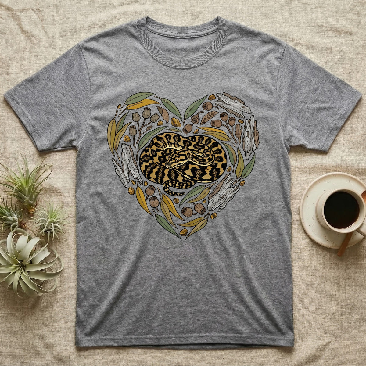 Grey t-shirt with coiled snake and eucalyptus heart design.