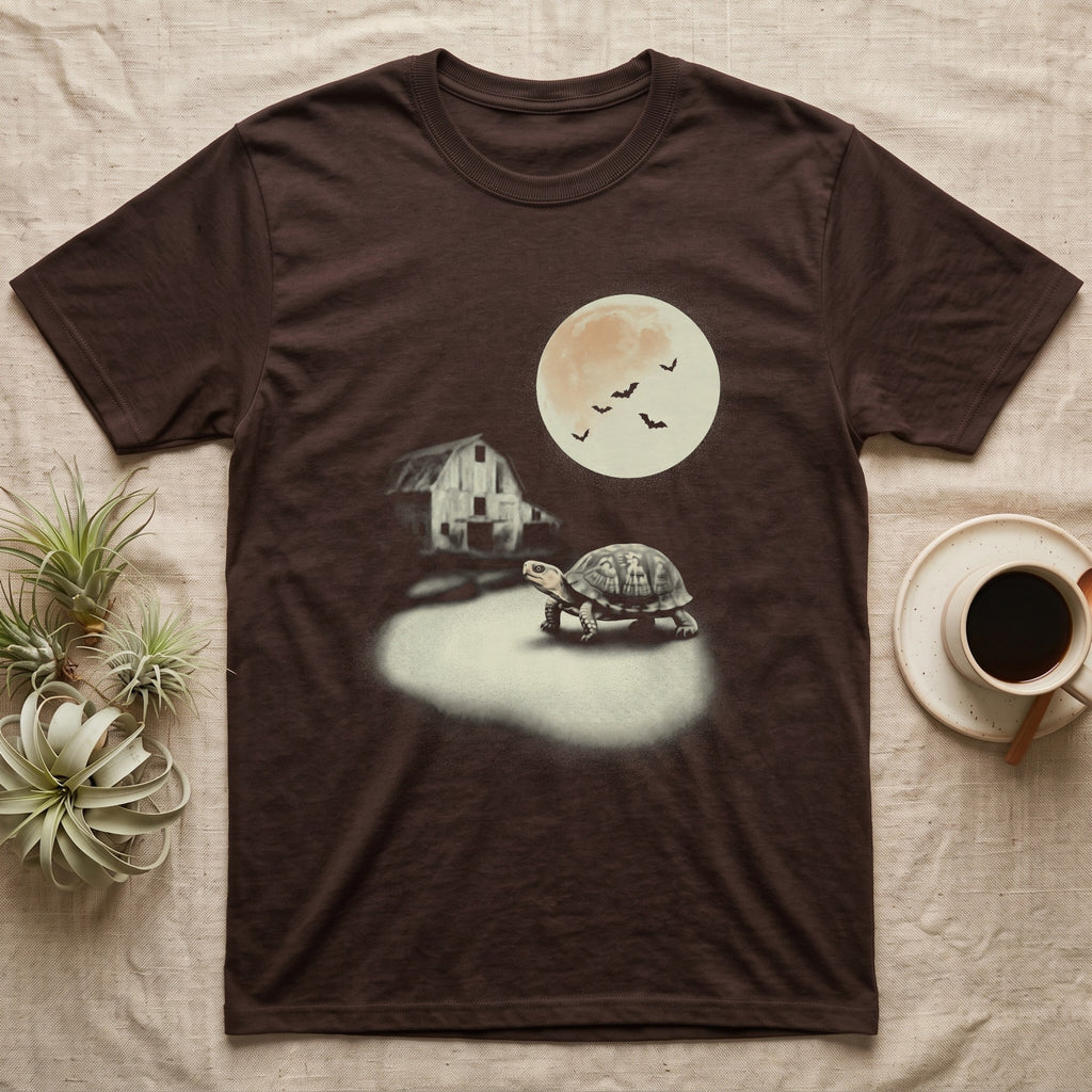 Box Turtle Moonlight T-Shirt in Dark Chocolate — An eastern box turtle mid-step across a moonlit yard, a derelict barn behind it and a large cream moon high right.
