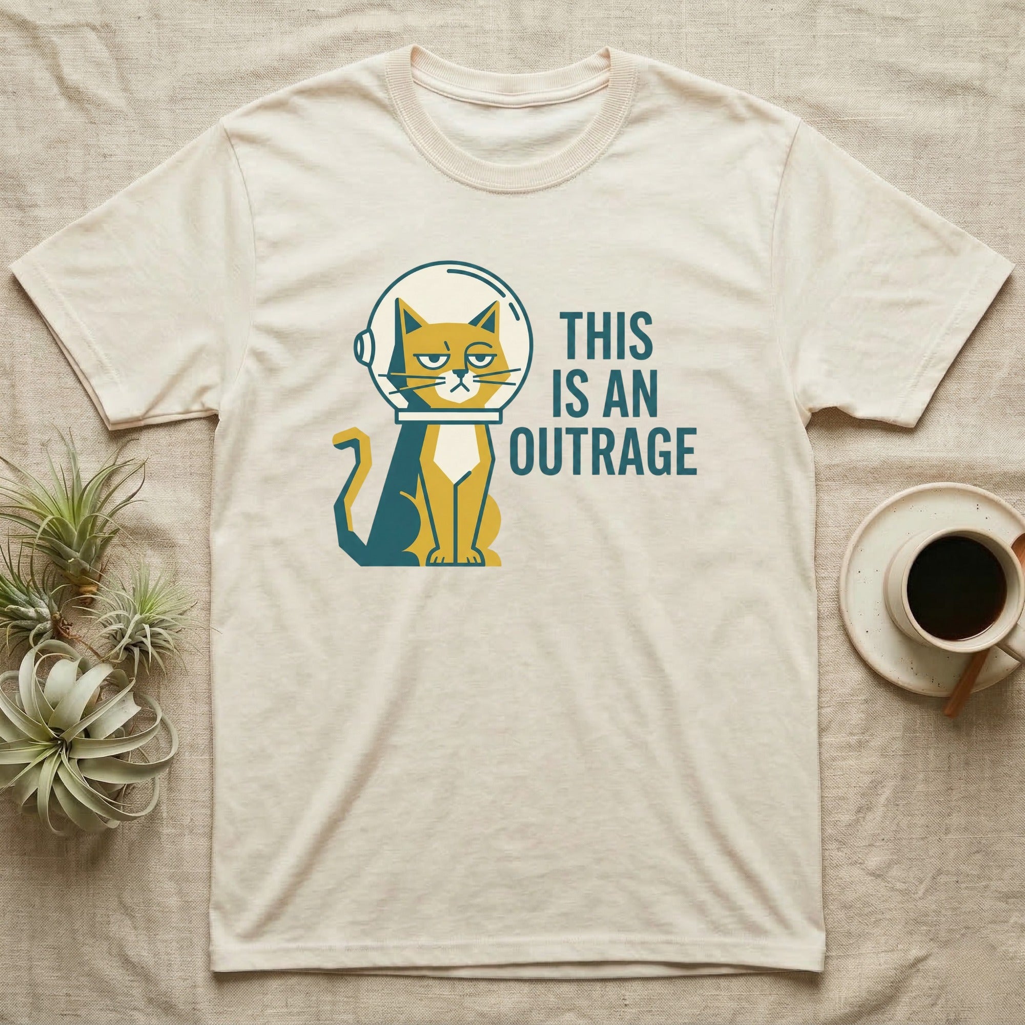 Cream t-shirt with a grumpy cat in a spacesuit saying "THIS IS AN OUTRAGE".