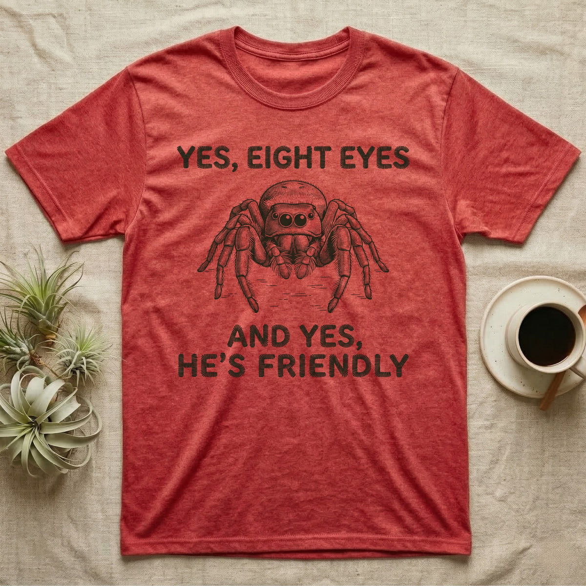 Jumping Spider Eight Eyes T-Shirt in Heather Red — Engraved jumping spider head-on with large forward eyes, between stitch-look lettering on grey.