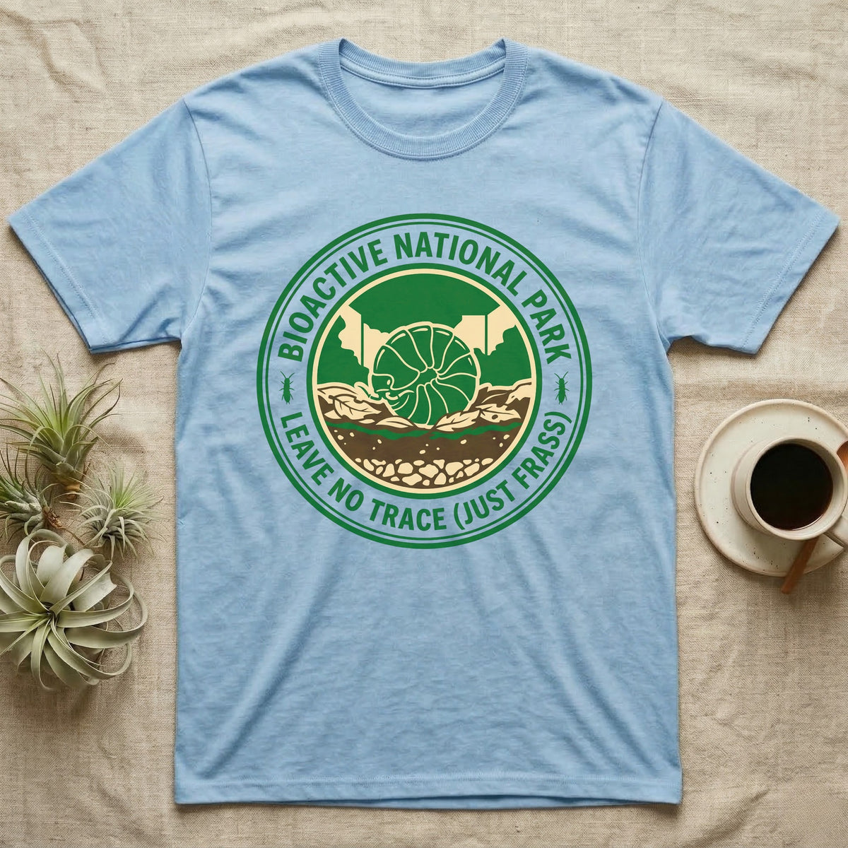Pillbug Bioactive National Park T-Shirt in Light Blue — Green ranger badge with a rolled pillbug in a cross-sectioned bioactive enclosure and springtail stars.