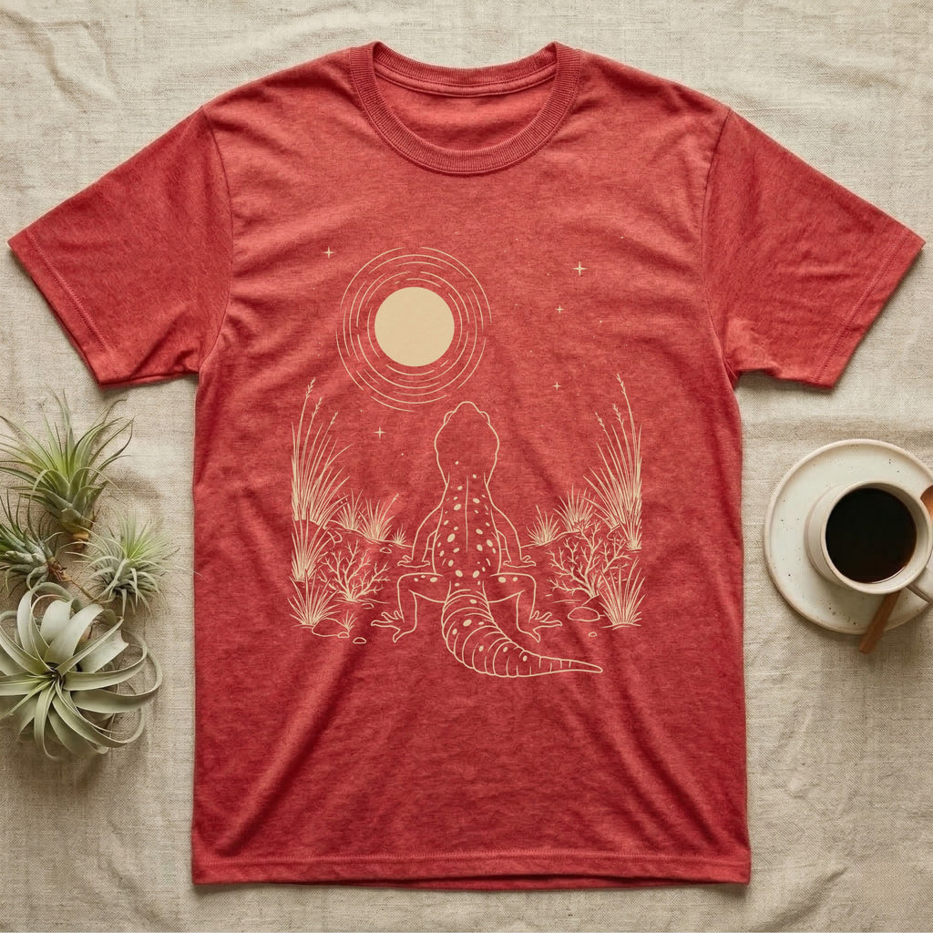 Leopard Gecko Moon T-Shirt in Heather Red — Scratchboard illustration of a leopard gecko seen from behind, looking up at a scratched moon over dry grasses.