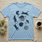 Light blue t-shirt with black cats in space with planets and stars.