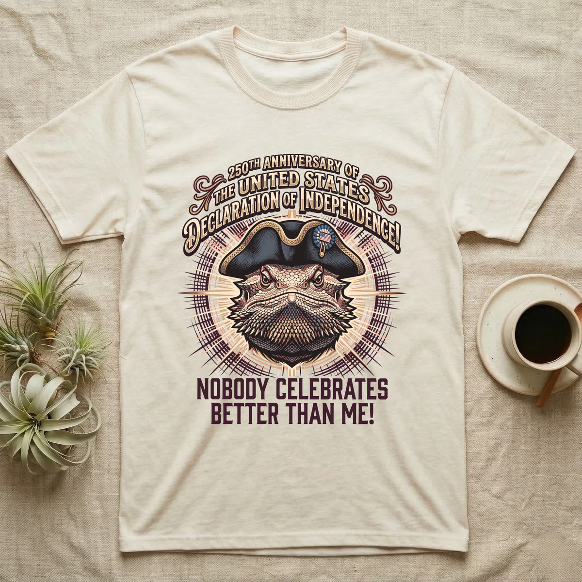 Bearded Dragon Declaration T-Shirt in Natural — Ornate engraved bearded dragon portrait in a tricorn hat on a cream sunburst with Nobody Celebrates Better Than Me.