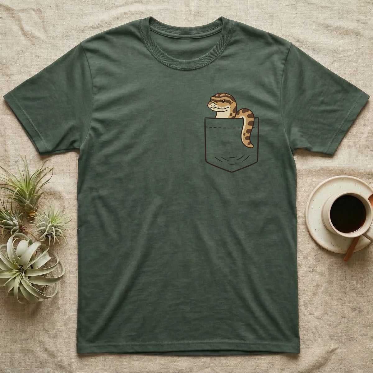 Hognose Pocket T-Shirt in Military Green — Cartoon western hognose with an upturned snout peeking out of a chest pocket, its body looped over the edge
