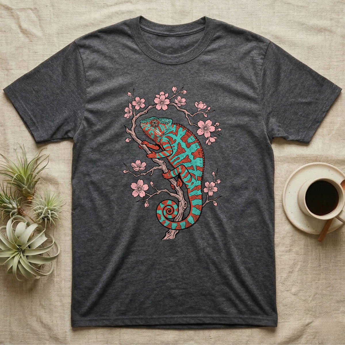 Dark gray t-shirt with teal and coral chameleon on a cherry blossom branch.
