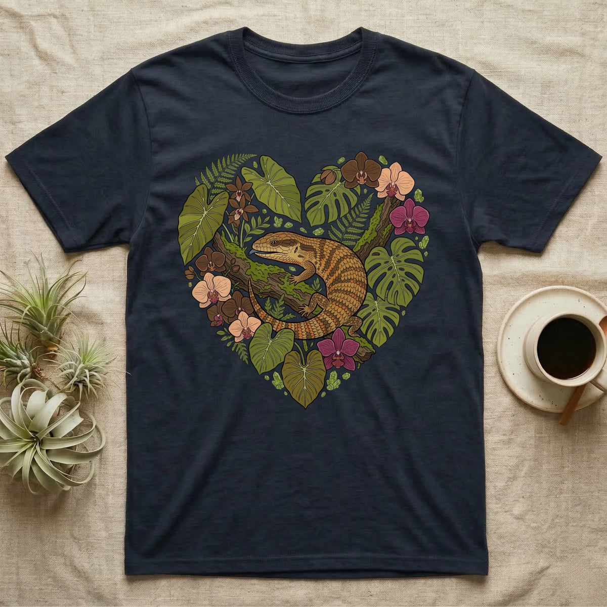 T-shirt with a heart-shaped botanical illustration featuring a lizard and flowers.