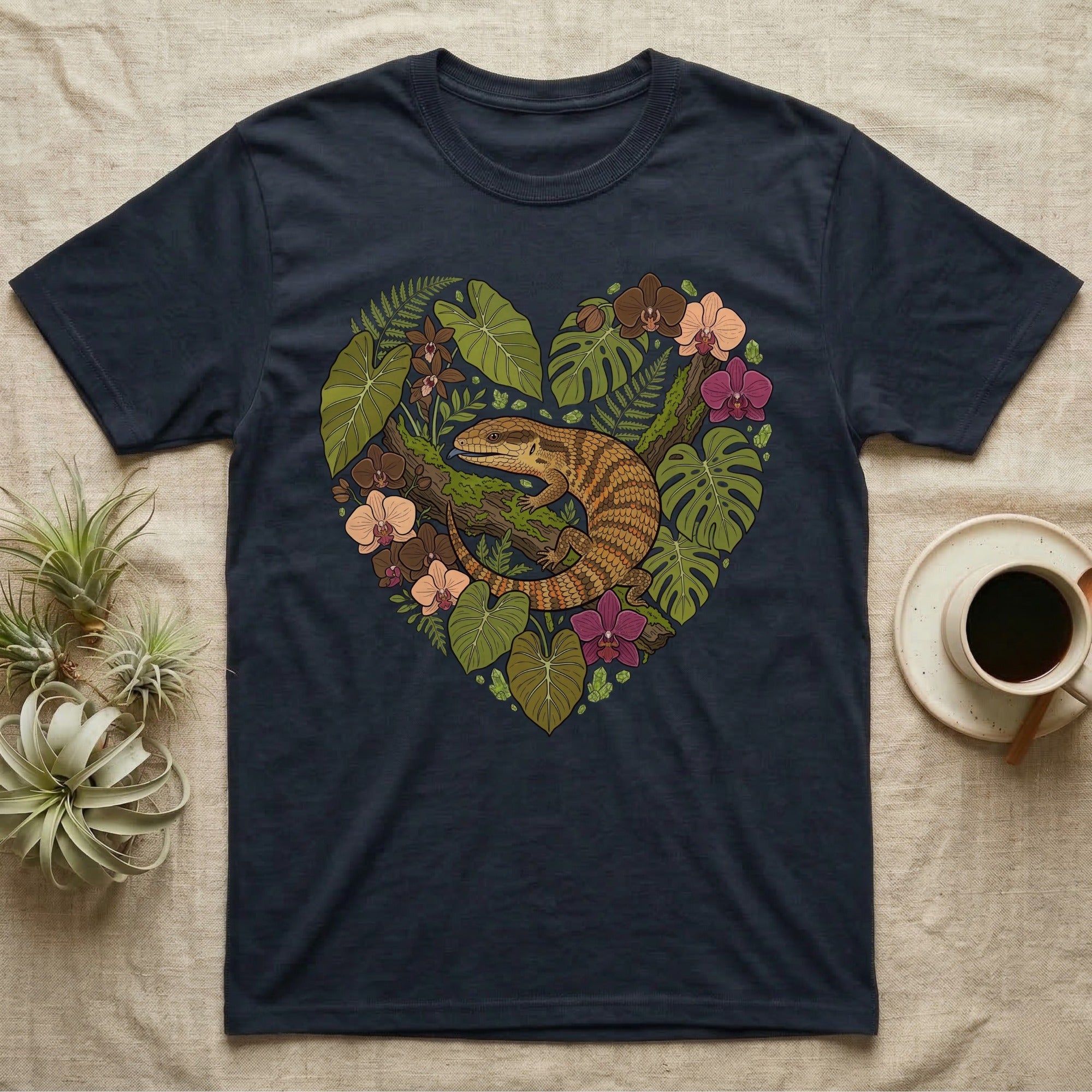 T-shirt with a heart-shaped botanical illustration featuring a lizard and flowers.
