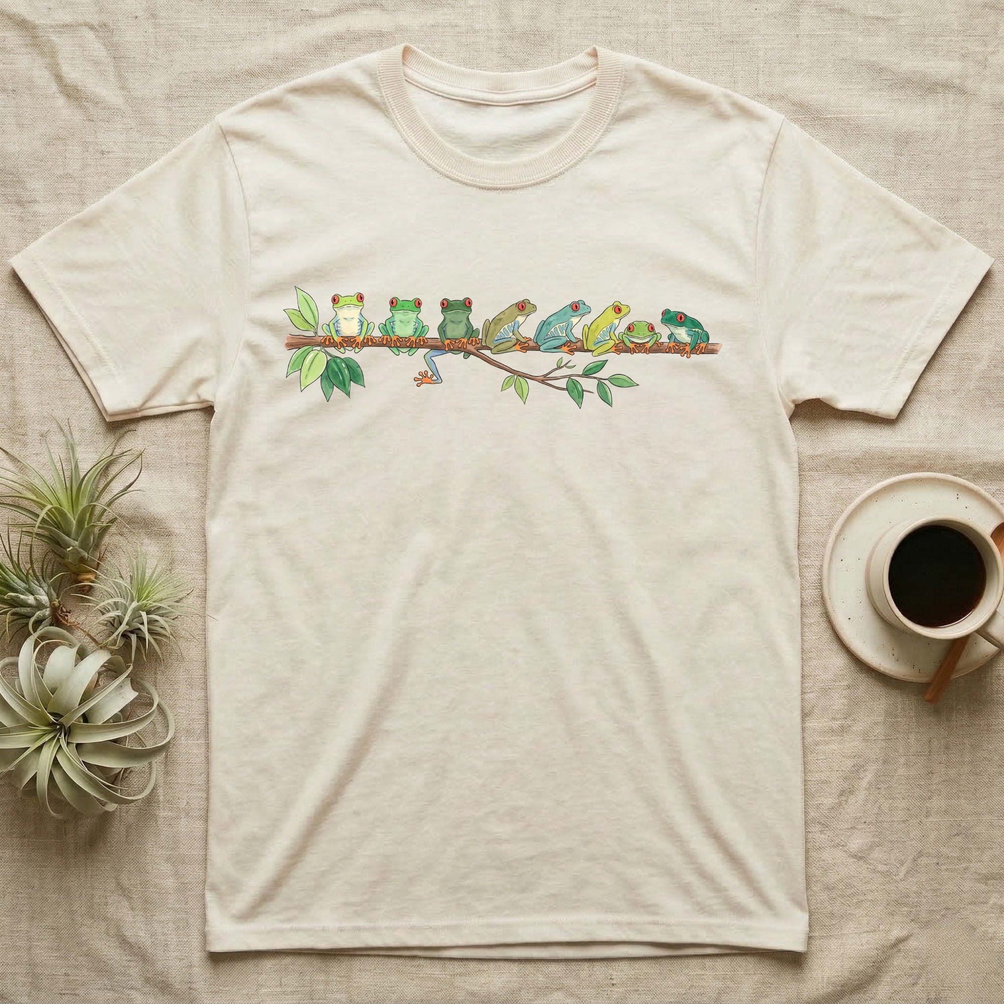 Red-Eyed Tree Frog Canopy Crew T-Shirt in Natural — Watercolor illustration of seven red-eyed tree frogs in varied green hues on a branch, dark grey T-shirt design.