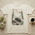 Cubaris Isopod Home Range T-Shirt in Natural — Woodcut-style illustration of a Cubaris isopod walking across leaf litter with cypress knees and saplings behind, no on-shirt text.