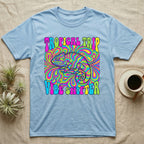Light blue t-shirt with psychedelic chameleon design and "Tropical Trip Vibe Shifter" text.
