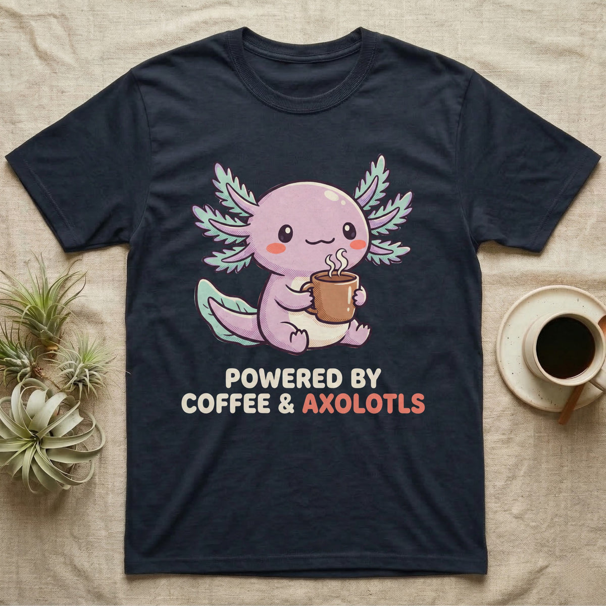 Coffee And Axolotls T-Shirt in Navy — Kawaii chibi illustration of an axolotl holding a coffee cup with soft text reading Powered By Coffee And Axolotls.