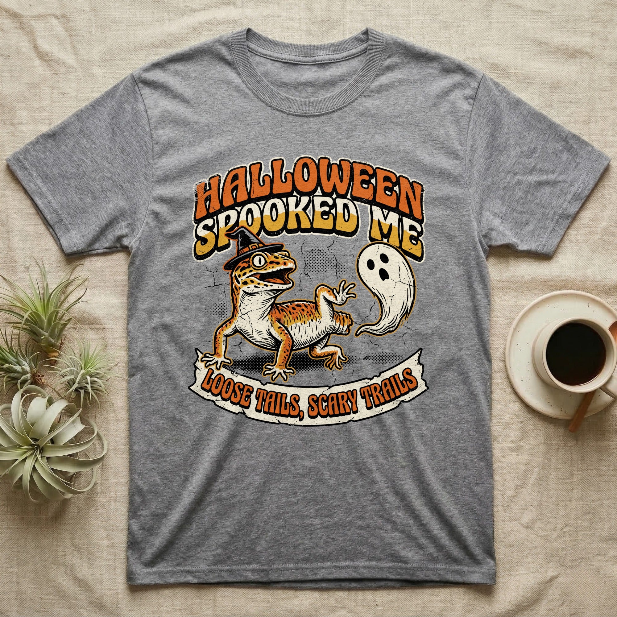 Leopard Gecko Spooked Me T-Shirt in Sport Grey — Distressed graphic of a shocked leopard gecko in a witch hat beside its ghost-costumed dropped tail, "Halloween Spooked Me."