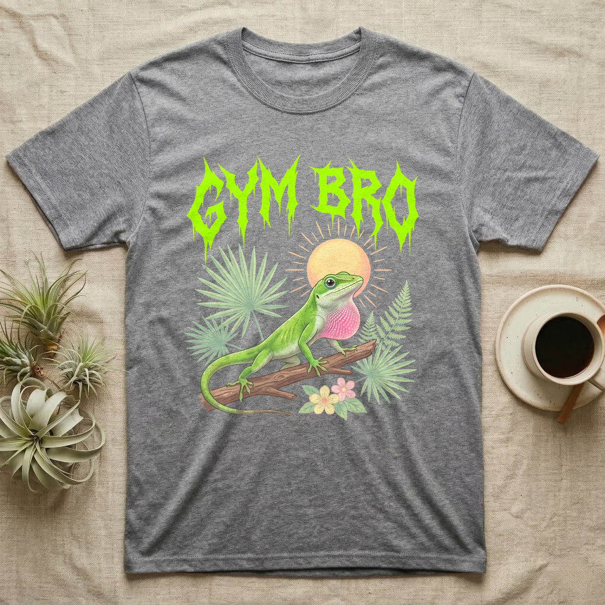 Green Anole Feral T-Shirt in Sport Grey — Green anole mid push-up with flared pink dewlap under a jagged neon-lime metal "GYM BRO" wordmark and pastel ferns.