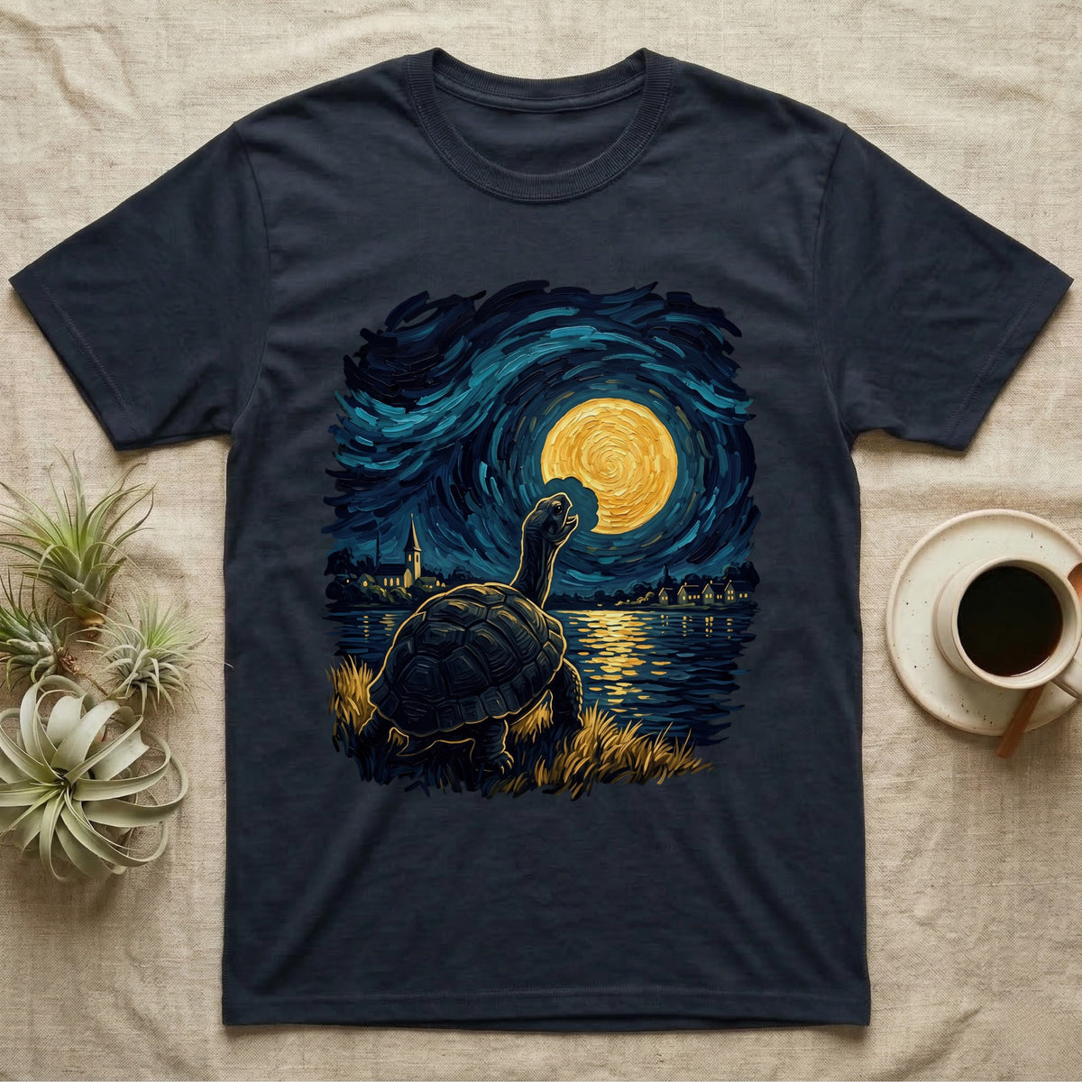 Hermann's Tortoise Moon T-Shirt in Navy — Painted Hermann's tortoise seen from behind, neck stretched up, biting a piece out of a golden spiral moon in a swirling blue night sky over a lake
