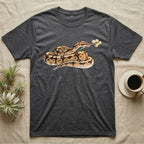 Ball Python Blossom T-Shirt in Dark Heather — Watercolor illustration of a tan-and-brown ball python holding an acacia blossom sprig, on a dark grey t-shirt.