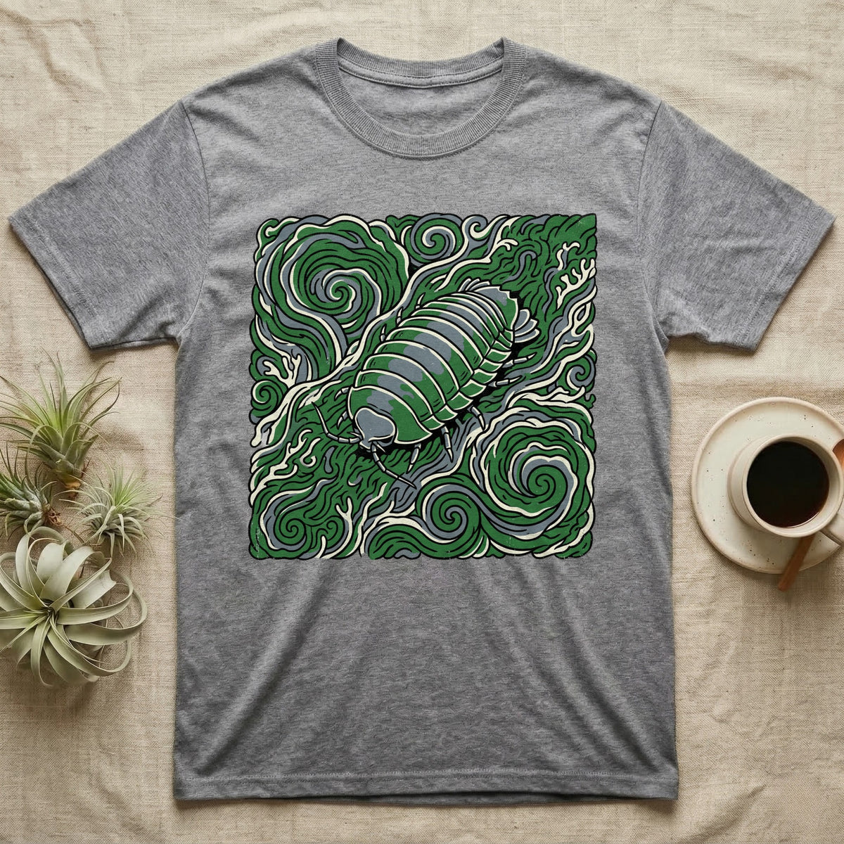 Grey t-shirt with a stylized pill bug graphic on a swirling green background.