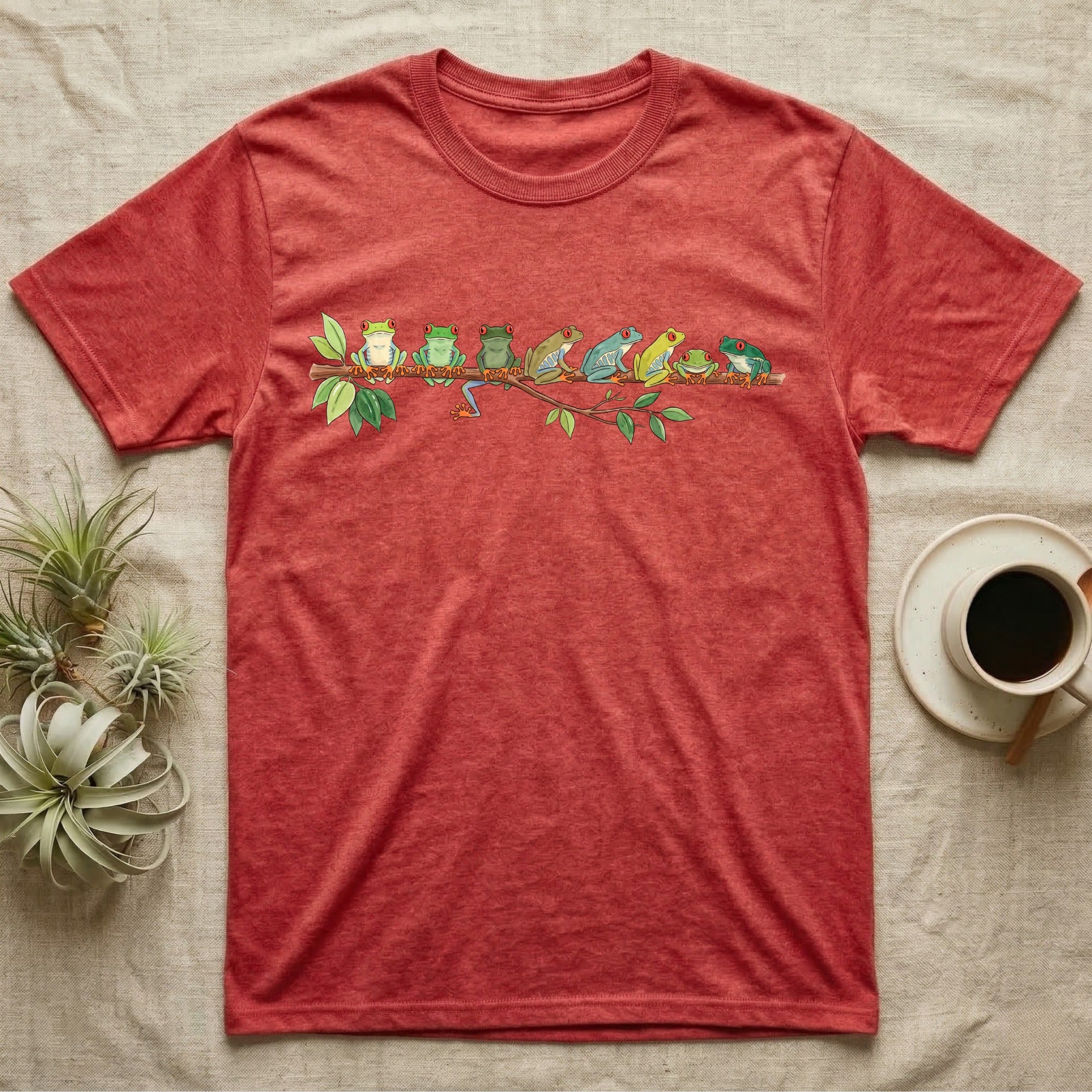 Red-Eyed Tree Frog Canopy Crew T-Shirt in Heather Red — Watercolor illustration of seven red-eyed tree frogs in varied green hues on a branch, dark grey T-shirt design.