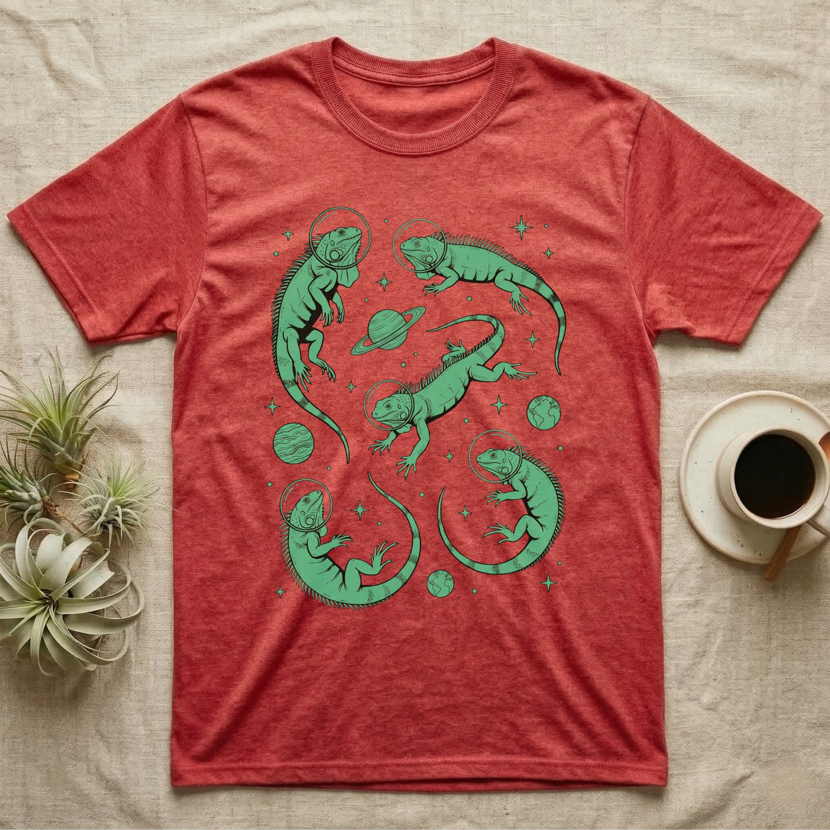 Green Iguana Cosmic T-Shirt in Heather Red — Vintage screen-print illustration of green iguanas in astronaut helmets floating in space, cosmic emerald green monochromatic on dark background.