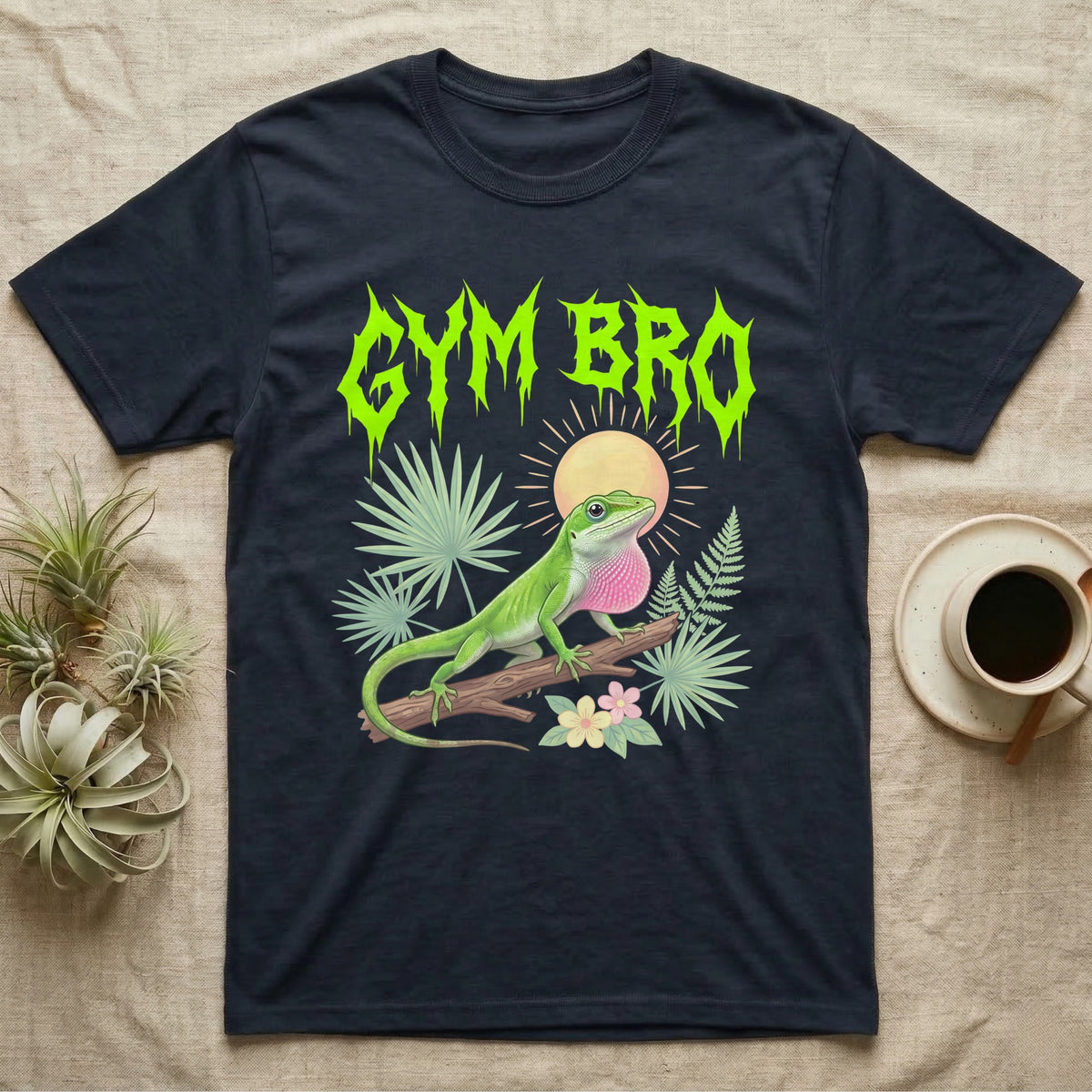 Green Anole Feral T-Shirt in Navy — Green anole mid push-up with flared pink dewlap under a jagged neon-lime metal "GYM BRO" wordmark and pastel ferns.