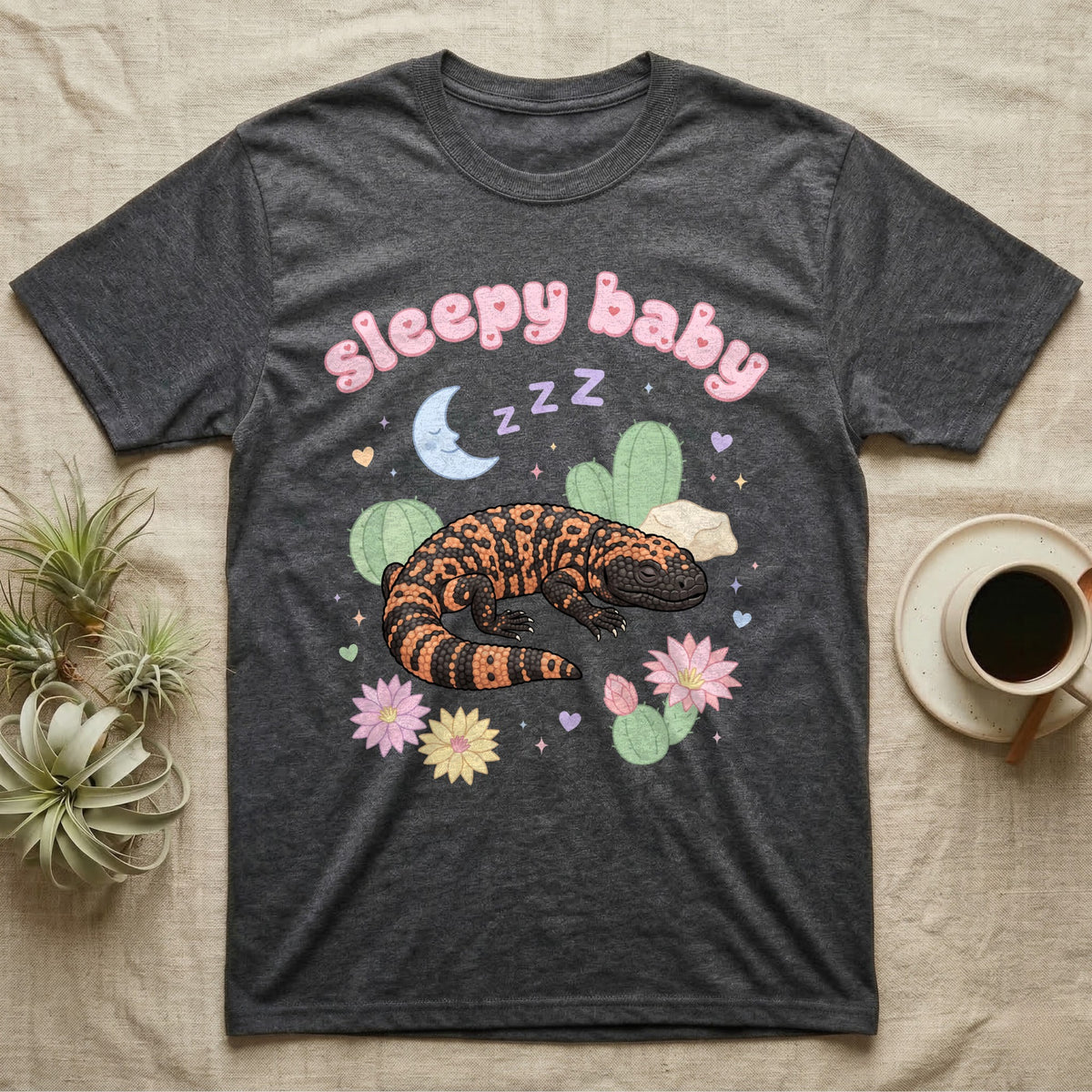 Gila Monster Baby T-Shirt in Dark Heather — Pastel Gila monster with sleepy eyes, crescent moon and Z Z Z, puffy salmon bubble wordmark "sleepy baby" above.