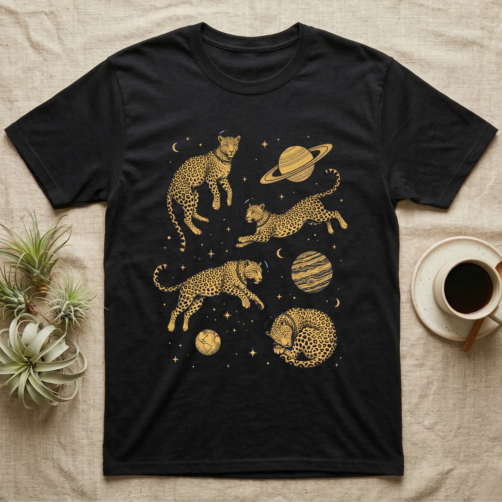 Black t-shirt with golden cheetahs and planets in space design.