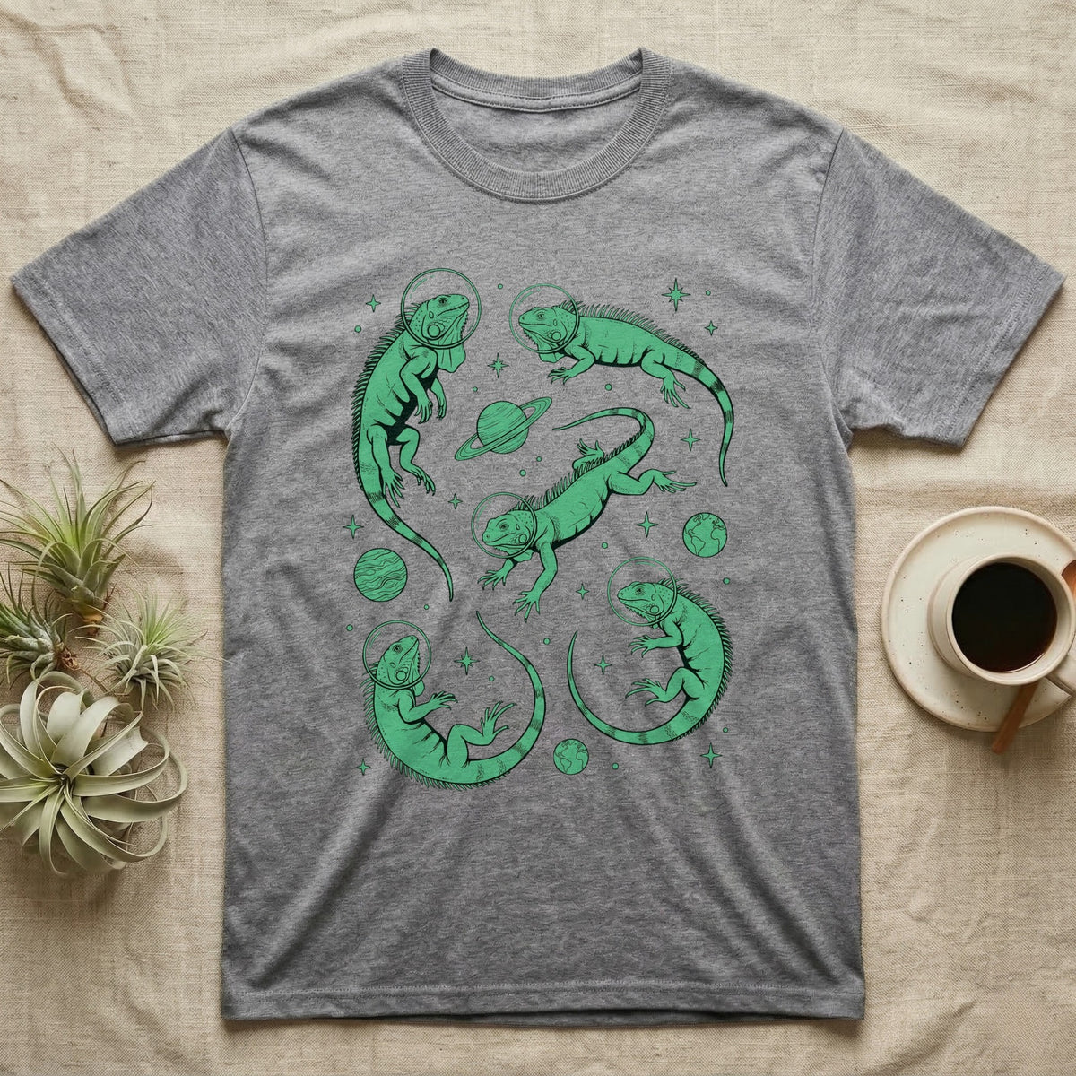 Green Iguana Cosmic T-Shirt in Sport Grey — Vintage screen-print illustration of green iguanas in astronaut helmets floating in space, cosmic emerald green monochromatic on dark background.