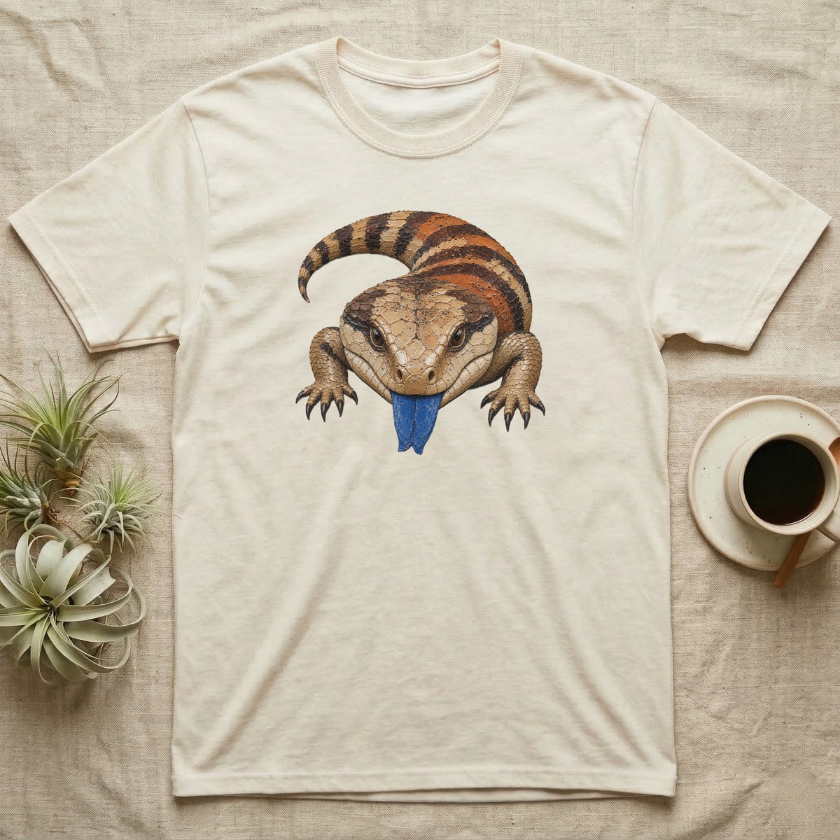 Cream t-shirt with a blue-tongued skink illustration.