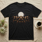 Red-Foot Tortoise Moon T-Shirt in Black — Three red-foot tortoises facing out beneath a full moon and nebula, warm low light, dissolving into black.